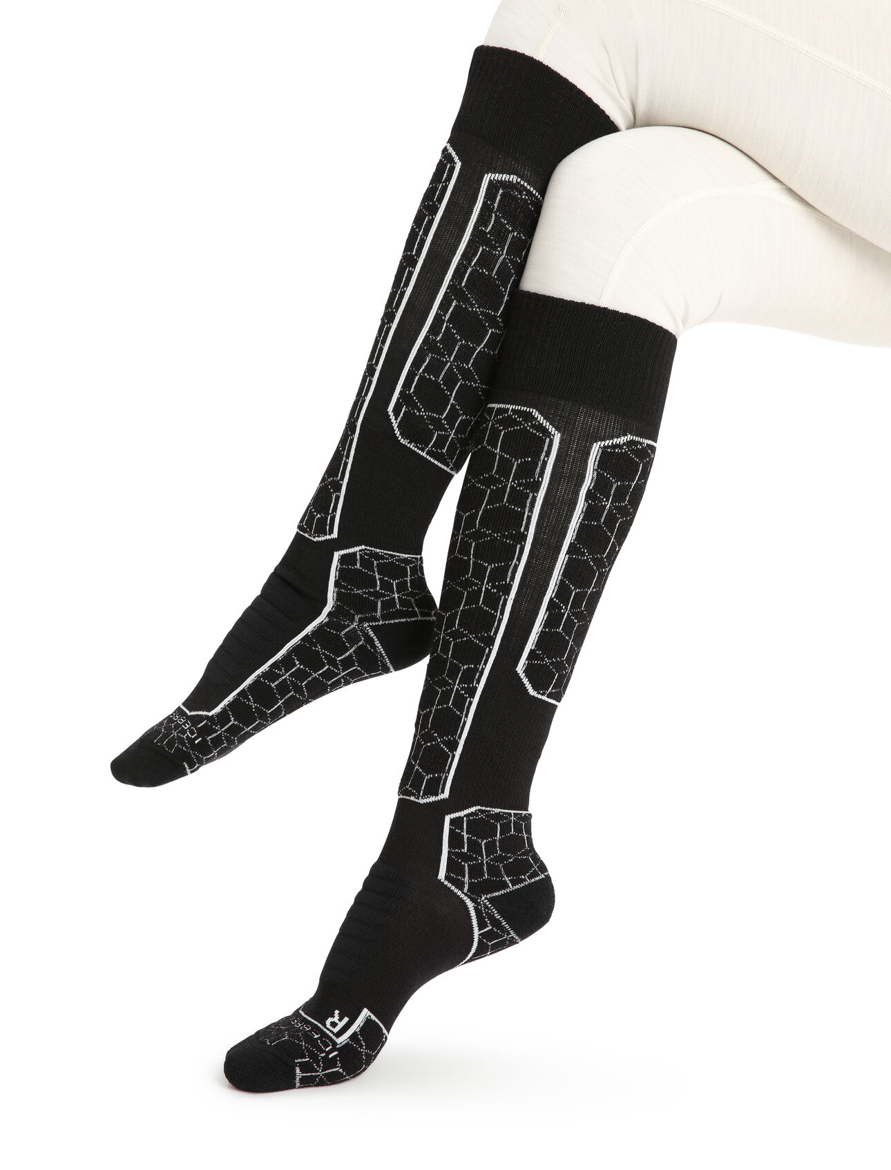 Womens Merino Ski+ Medium Over the Calf Alpine Geo Fully cushioned ski socks for skiing the resort or the backcountry,  the Ski+ Medium Over the Calf Alpine Geo socks are made with a durable, breathable merino wool blend.