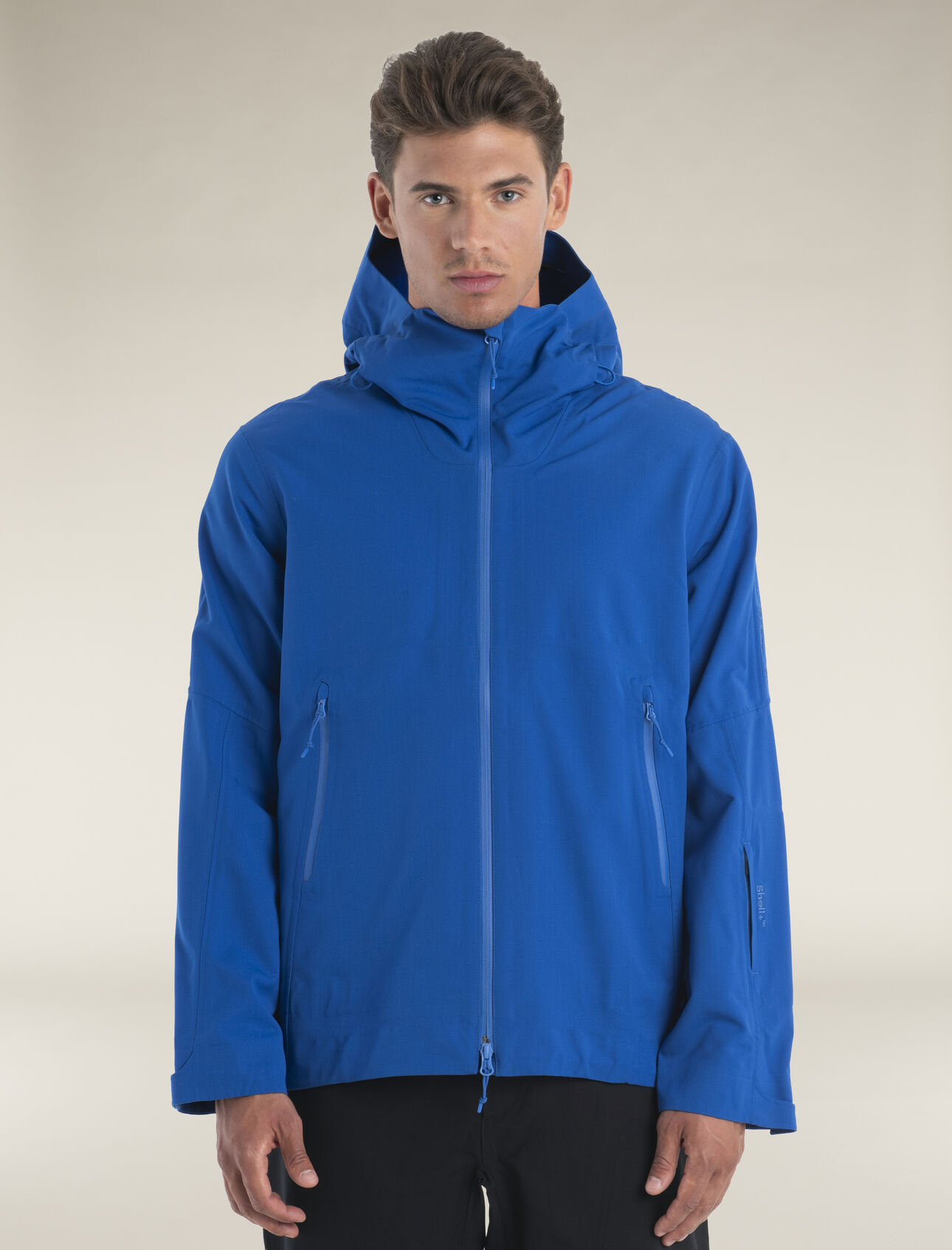 Mens Merino Shell+™ Peak Hooded Jacket The Shell+™ Peak Hooded Jacket is an innovative technical shell made with merino wool. The jacket's woven merino fabric features a PFC-free DWR finish to shed wind, snow and light rain, and is seam sealed for added moisture protection. The three-way adjustable storm hood fits with or without a helmet, and the high collar is shaped for comfort and added protection. Articulated sleeves enhance range of motion, and zippered alpine hand pockets and a ski pass pocket keep your essentials secure.