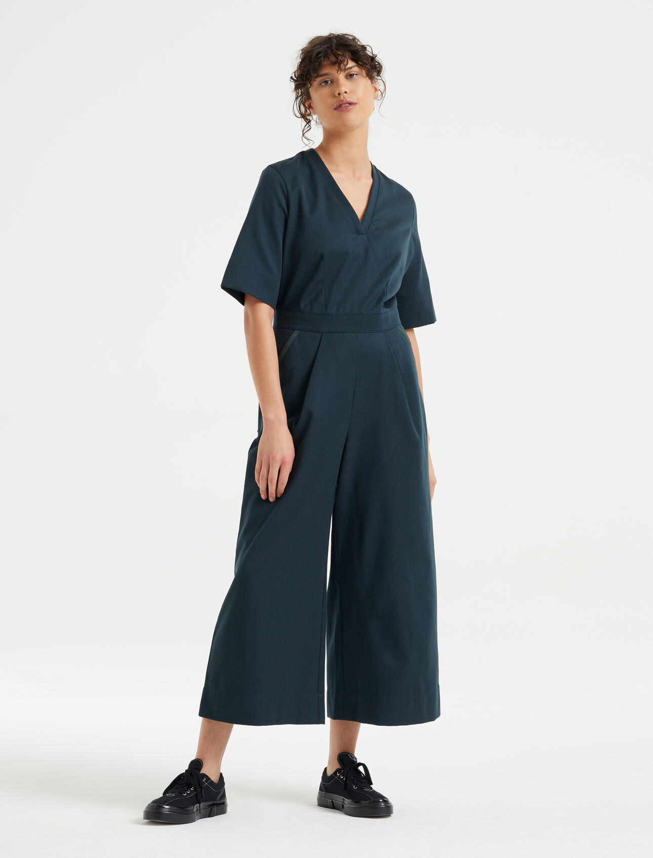 Womens Merino Natural Blend Jumpsuit A modern take on the classic jumpsuit, the Merino Natural Blend Short Sleeve Jumpsuit features a woven blend of merino wool and organic cotton, lined with Cool-Lite™ for breathable comfort and style.