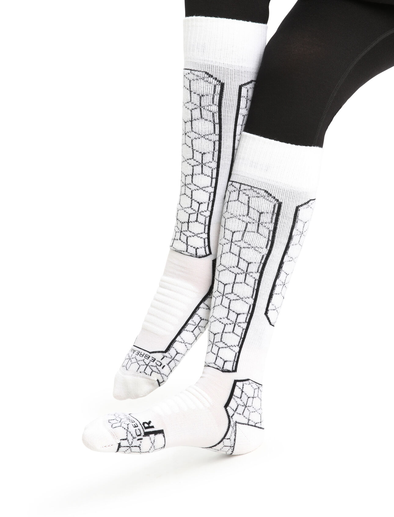 Womens Merino Ski+ Medium Over the Calf Alpine Geo Fully cushioned ski socks for skiing the resort or the backcountry,  the Ski+ Medium Over the Calf Alpine Geo socks are made with a durable, breathable merino wool blend.