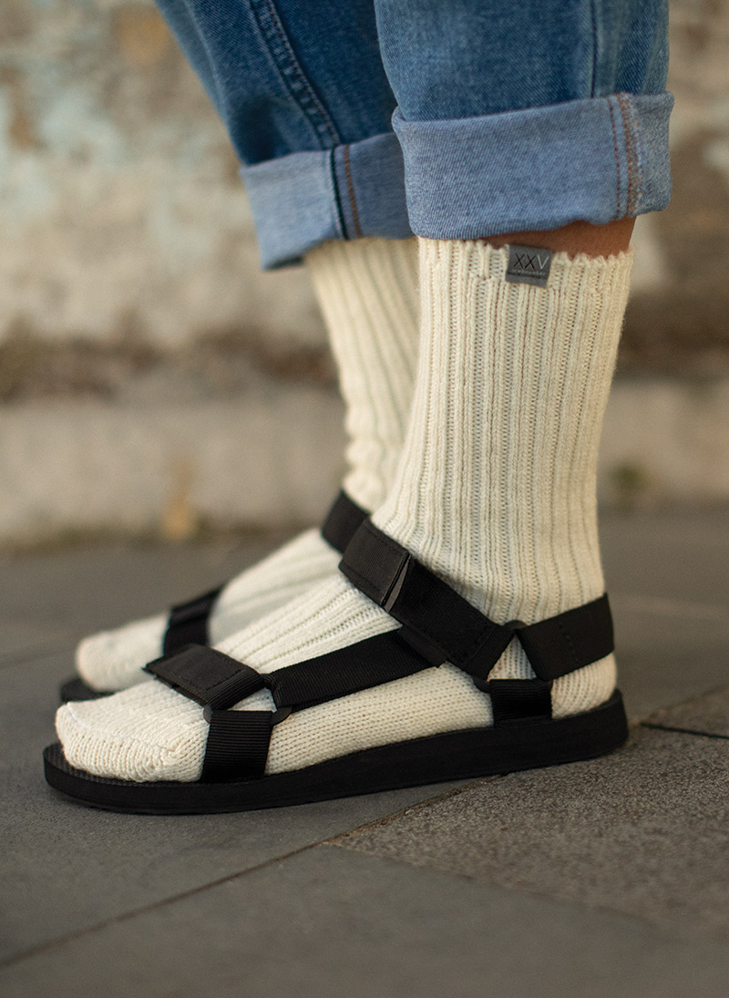 Woman wearing XXV collection tan socks in a pair of sandals.