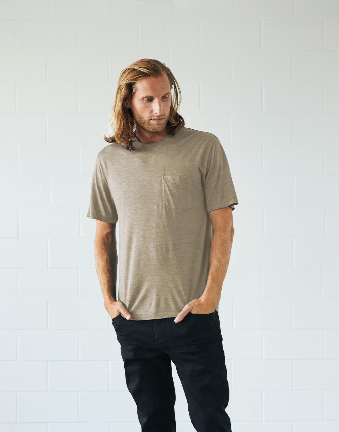 Man standing wearing a t-shirt dyed using natural, sustainably sourced plant pigments.