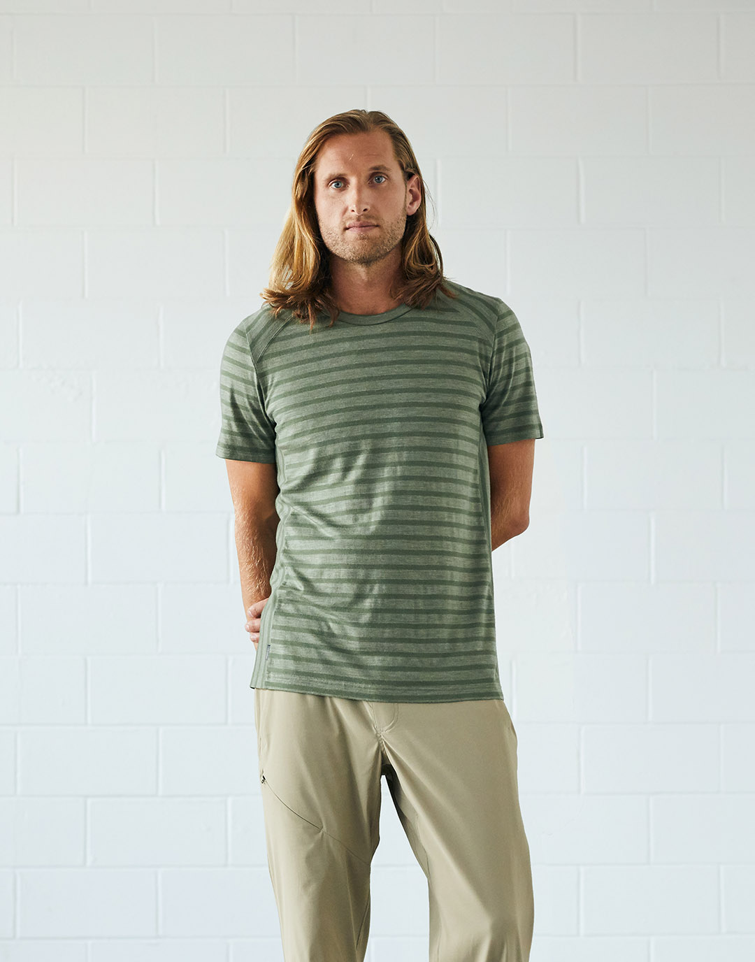 Man in green striped t-shirt and khaki pants.